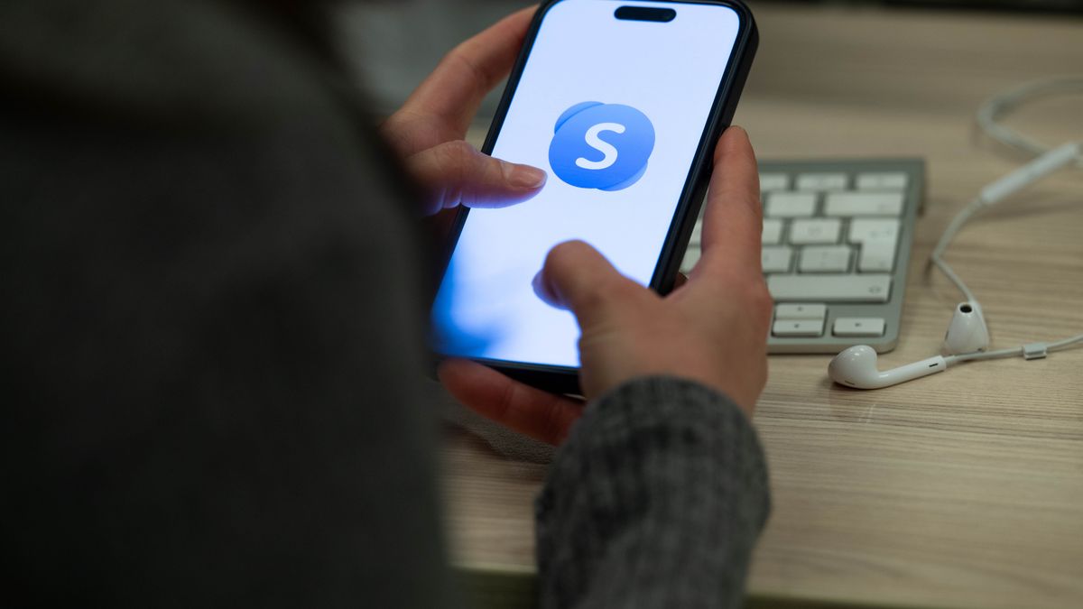 ANKARA, TURKIYE - FEBRUARY 28: A person holds a mobile phone displaying Skype application, in Ankara, Turkiye on February 28, 2025. (Photo by Didem Mente/Anadolu via Getty Images)