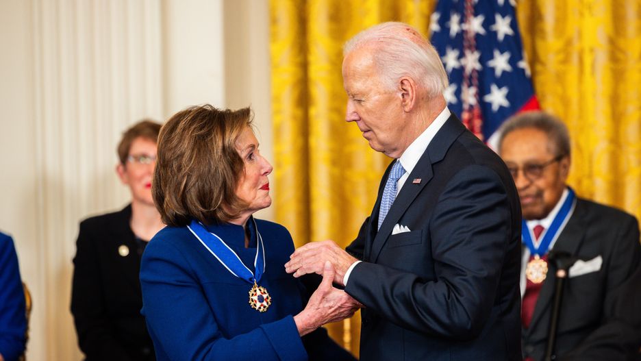 US President Joe Biden, center right, and Representative Nancy Pelosi, a Democrat from California, during a medal of freedom ceremony in the East Room of the White House in Washington, DC, US, on Friday, May 3, 2024. The Presidential Medal of Freedom is the nation's highest civilian honor, presented to individuals who have made exemplary contributions to the prosperity, values, or security of the United States. Photographer: Tierney L. Cross/Bloomberg via Getty Images