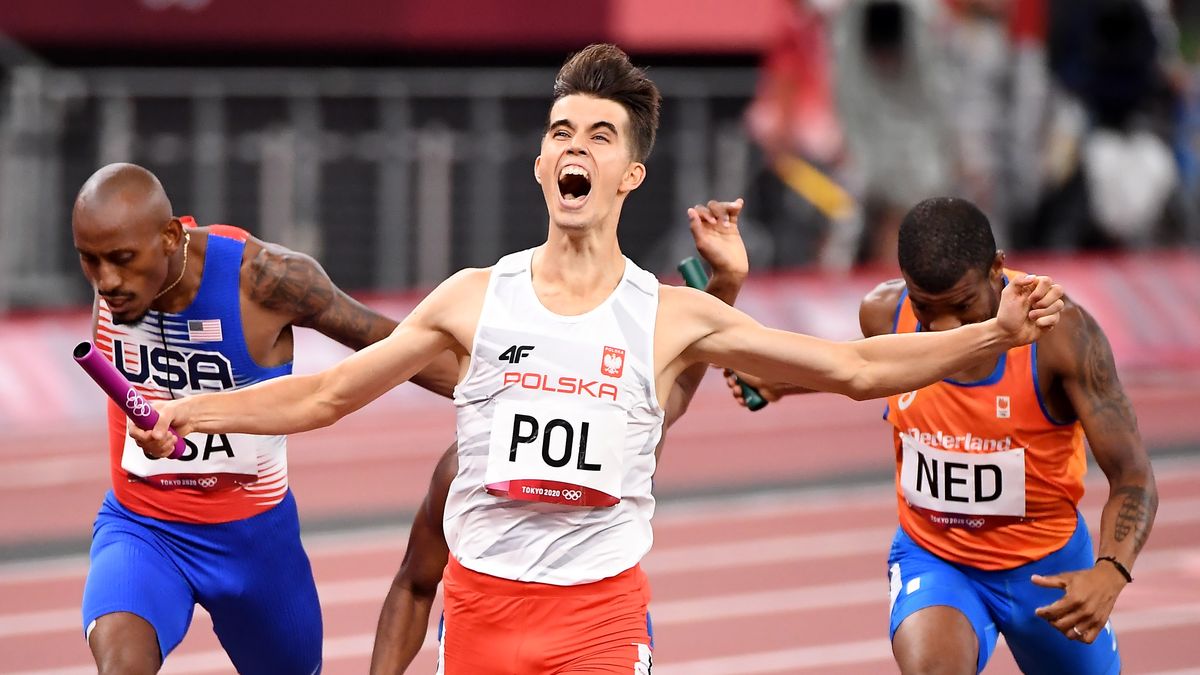 -TOKYO,JAPAN July 31, 2021: Kajetan Duszynski crosses the finish line first for team Poland and capture the 4X400 relay mixed race at the 2020 Tokyo Olympics.  (Wally Skalij /Los Angeles Times via Getty Images)