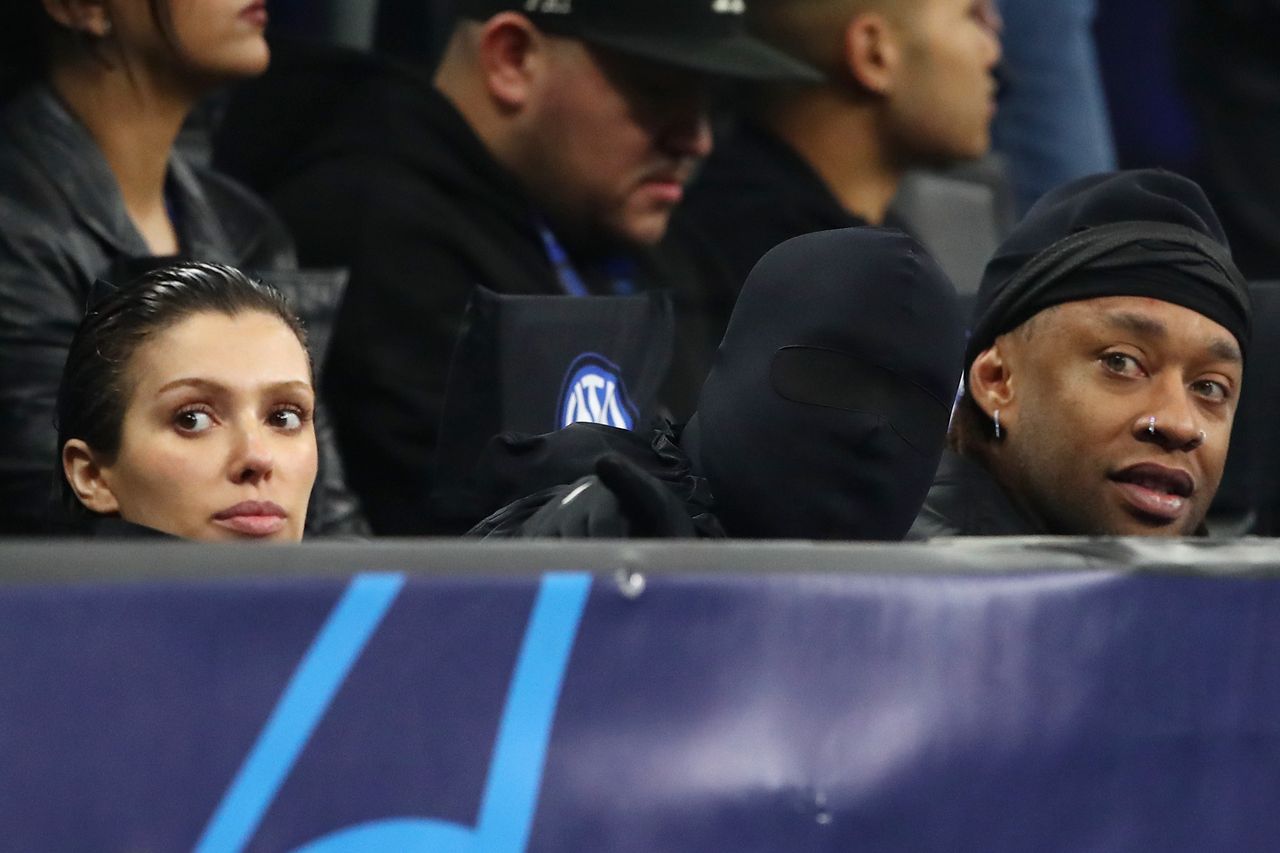 MILAN, ITALY - FEBRUARY 20: American musician and fashion designer, Kanye West (C), his partner Bianca Censori (L), and Amreican musician, Ty Dolla Sign (R), are seen in attendance during the UEFA Champions League 2023/24 round of 16 first leg match between FC Internazionale and Atletico Madrid at Stadio Giuseppe Meazza on February 20, 2024 in Milan, Italy. (Photo by Marco Luzzani/Getty Images)