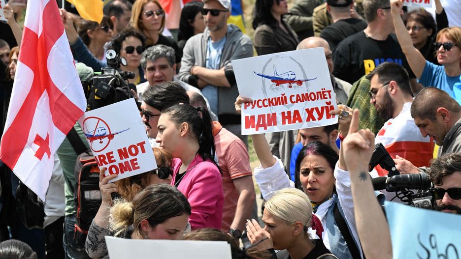 TemporaryA picture taken on May 19, 2023 shows demonstrators protesting against the resumption of air links with Russia outside the Tbilisi Airport as the first direct flight from Moscow arrives in Tbilisi. Last week, Russian President Vladimir Putin lifted a flight ban with Georgia, against which Russia fought a brief war in 2008. Putin has also introduced a 90-day visa-free regime for Georgian citizens, after Russia in 2019 banned air travel with the country in response to anti-Moscow rallies in Georgia. (Photo by Vano SHLAMOV / AFP)VANO SHLAMOV
