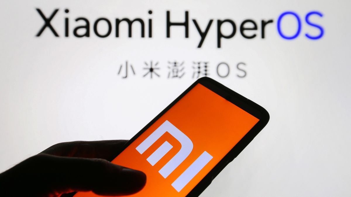 UKRAINE - 2023/10/21: In this photo illustration, Xiaomi logo is seen displayed on a smartphone and Xiaomi HyperOS logo in the background. (Photo Illustration by Pavlo Gonchar/SOPA Images/LightRocket via Getty Images)