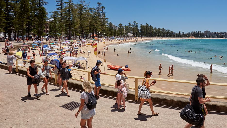 SYDNEY, AUSTRALIA - JANUARY 16: (EDITORS NOTE: A polarizing filter was used for this image.) Beachgoers enjoy the warm weather, protected from the wind at Manly Beach on January 16, 2021 in Sydney, Australia. The Bureau of Meteorology has forecast sunny conditions and 26C (79F) degrees in the Greater Sydney region. (Photo by Lee Hulsman/Getty Images)
