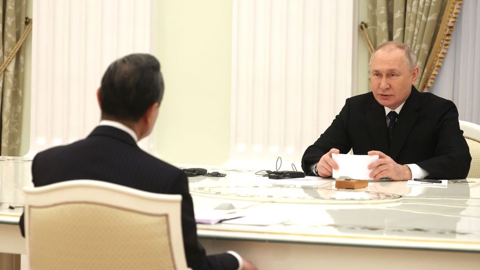 MOSCOW, RUSSIA - FEBRUARY 22: (----EDITORIAL USE ONLY - MANDATORY CREDIT - 'KREMLIN PRESS OFFICE / HANDOUT' - NO MARKETING NO ADVERTISING CAMPAIGNS - DISTRIBUTED AS A SERVICE TO CLIENTS----) Russian President Vladimir Putin and Chinese Foreign Minister Vang Yi meet on February 22, 2023, in Moscow, Russia. (Photo by Kremlin Press Office/Handout/Anadolu Agency via Getty Images)