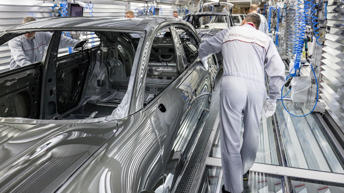 LEIPZIG, GERMANY - MAY 6: Workers assemble the new all electric Porsche Macan at the Porsche assembly plant on May 6, 2024 in Leipzig, Germany. The electric Macan is Porsche's second electric car after the Taycan. The company also offers two hybrid cars. (Photo by Jens Schlueter/Getty Images)