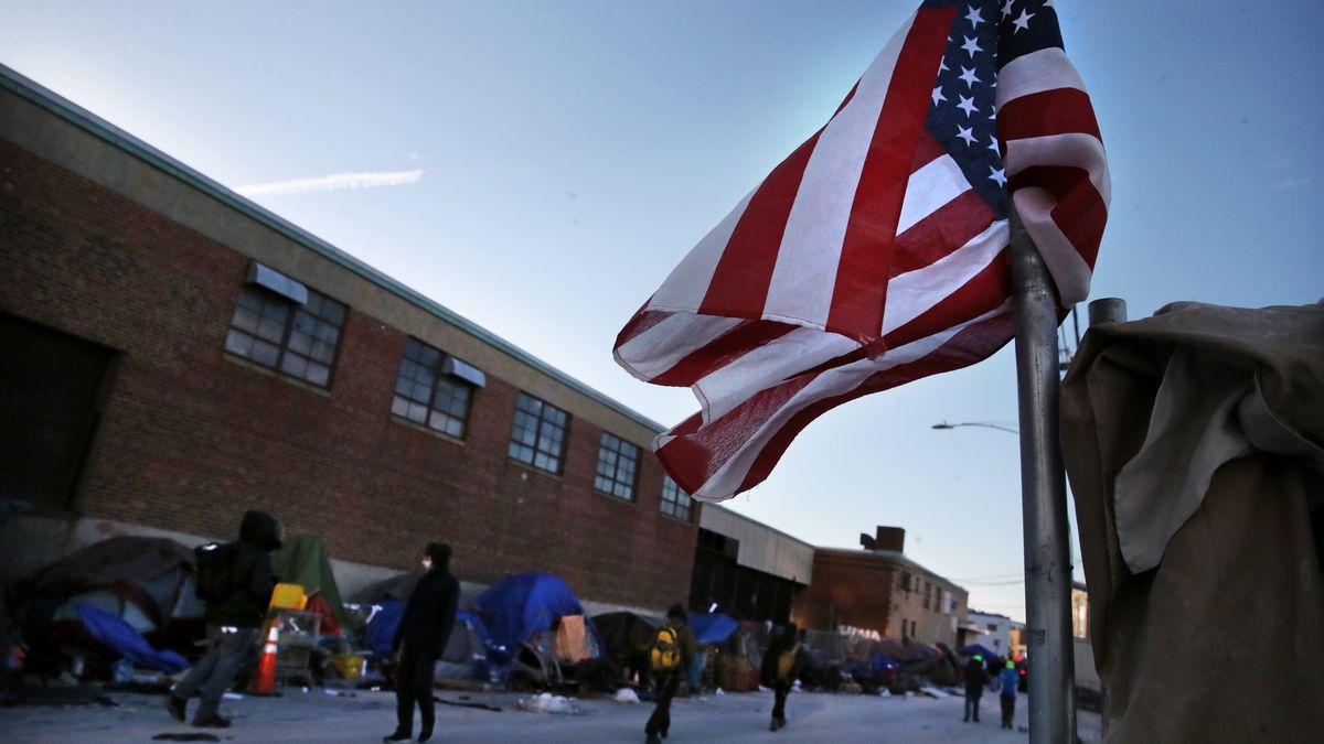 Boston - January 12: An American flag flies on Atkinson Street in Boston, MA on January 12, 2022. City crews began taking down tent encampments Wednesday morning in the area known as Mass. and Cass, as the Wu administration said it had created enough suitable housing to accommodate people who have been living on the streets. (Photo by Craig F. Walker/The Boston Globe via Getty Images)