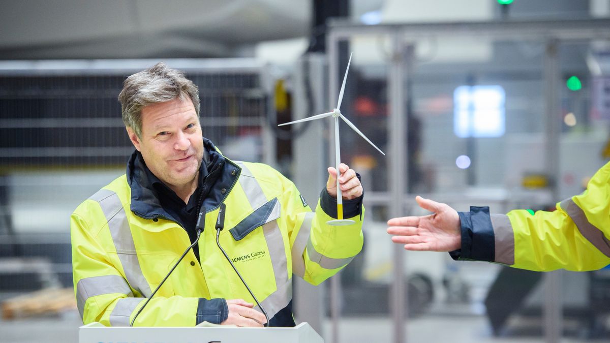 CUXHAVEN, GERMANY - JANUARY 31: German Federal Economy and Climate Action Minister Robert Habeck (l-r) gets a model wind turbine from Chief Executive Officer of Siemens Gamesa Renewable Energy Jochen Eickholt during a press conference while visiting the Siemens Gamesa wind turbine factory on January 31, 2023 in Cuxhaven, Germany. Siemens Gamesa specialises in wind turbines for offshore wind parks. (Photo by Gregor Fischer/Getty Images)