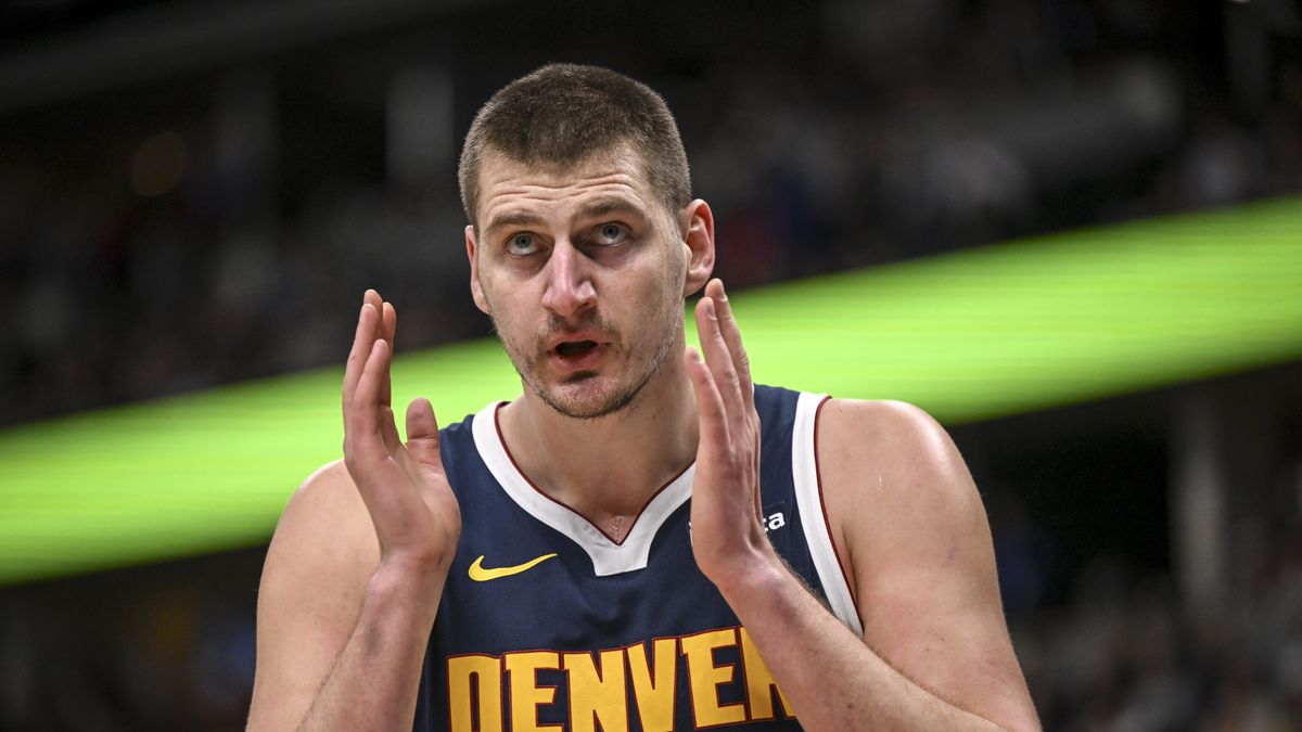 DENVER, CO - DECEMBER 28: Nikola Jokic (15) of the Denver Nuggets reacts to a defensive foul by Michael Porter Jr. (1) on Vince Williams Jr. (5) of the Memphis Grizzlies during the second quarter at Ball Arena in Denver on Thursday, December 28, 2023. (Photo by AAron Ontiveroz/The Denver Post)