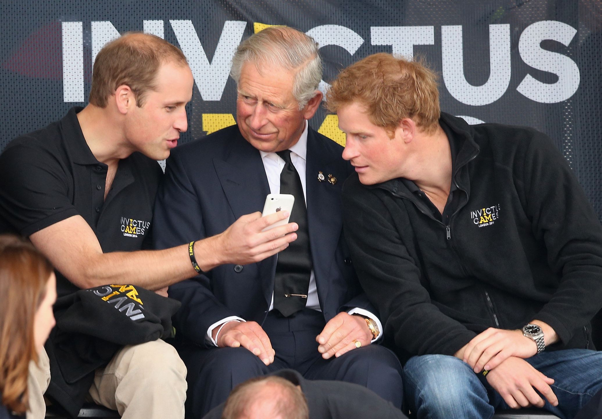 Invictus Games:  AthleticsLONDON, ENGLAND - SEPTEMBER 11:  Prince William, Duke of Cambridge, Prince Harry and Prince Charles, Prince of Wales look at a mobile phone as they watch the athletics at Lee Valley Track during the Invictus Games on September 11, 2014 in London, England. The International sports event for 'wounded warriors', presented by Jaguar Land Rover, is just days away with limited last-minute tickets available at www.invictusgames.org  (Photo by Chris Jackson/Getty Images)Chris JacksonBritish Royalty,Celebrities,Human Interest,Music,Royalty