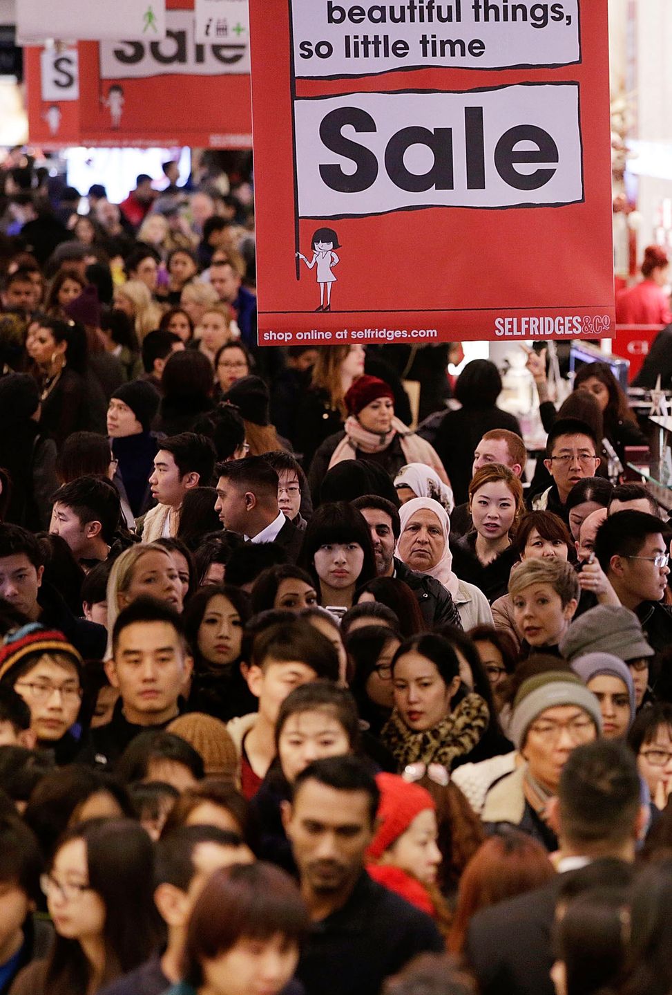 LONDON, ENGLAND - DECEMBER 26:  Members of the public cram into Selfridges for the Boxing Day sales on December 26, 2013 in London, England. Statistics have shown that this year people are more likely to shop in the sales online than on the high street for the first time.  (Photo by Matthew Lloyd/Getty Images) 