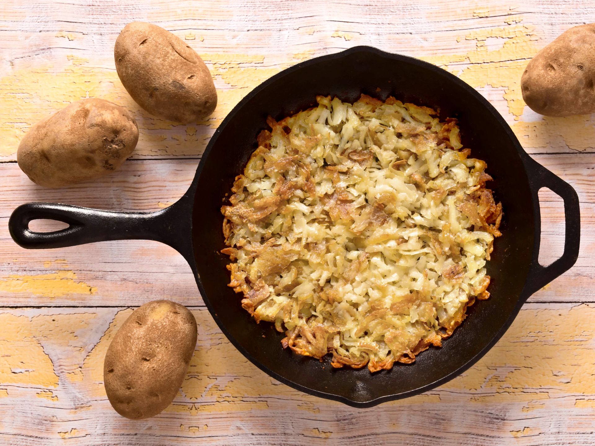 close up of a pan of fried rosti potatoes 