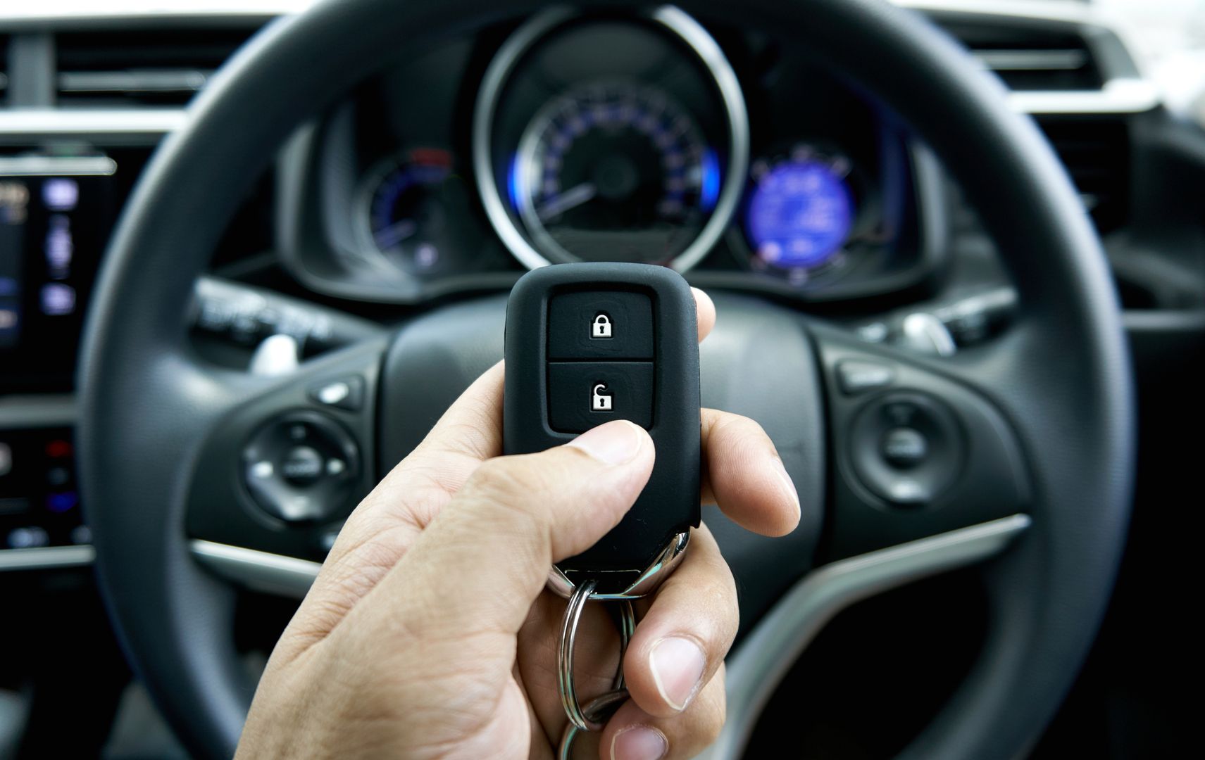 car key on hand inside the car