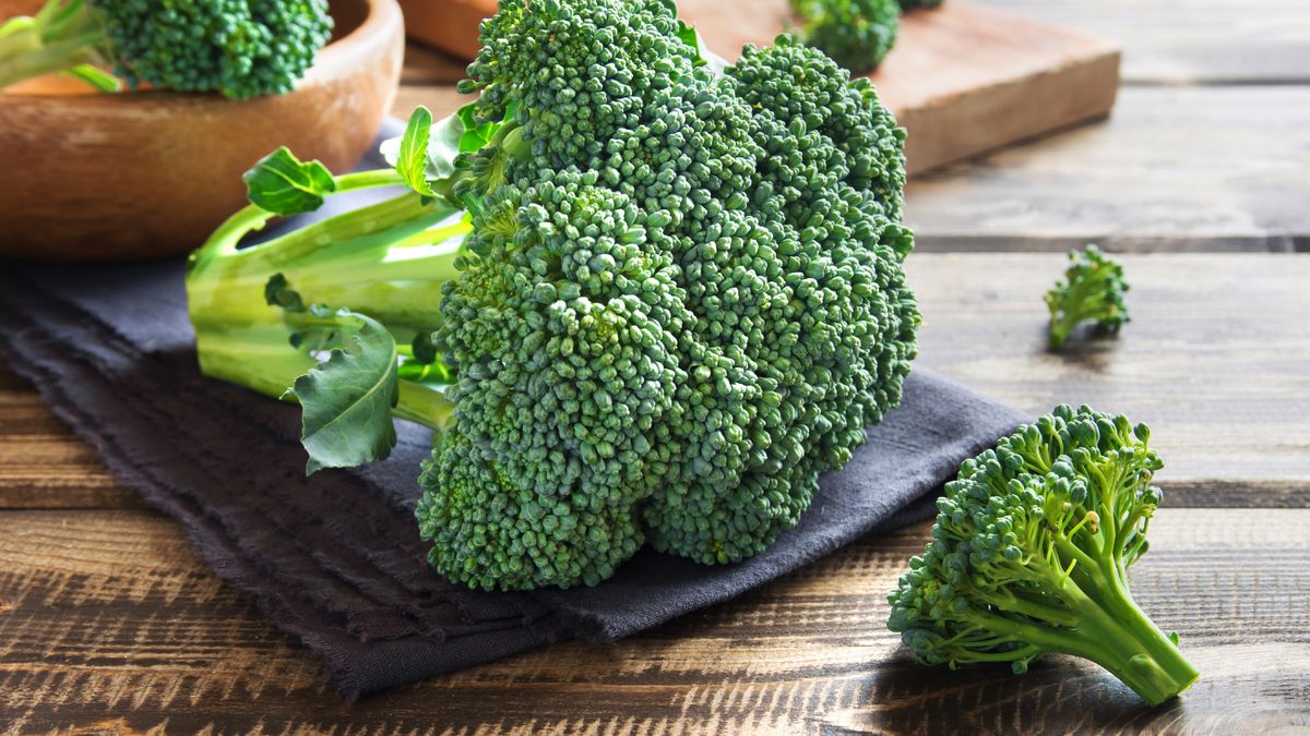 Healthy green organic raw broccoli on wooden table 