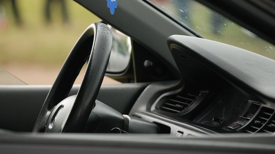 transportation and ownership concept - man with car documents outside