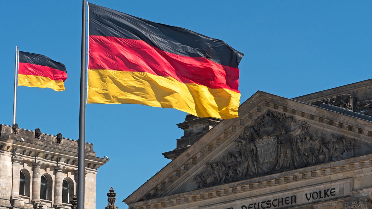 two Germany flags on top of the Reichstag