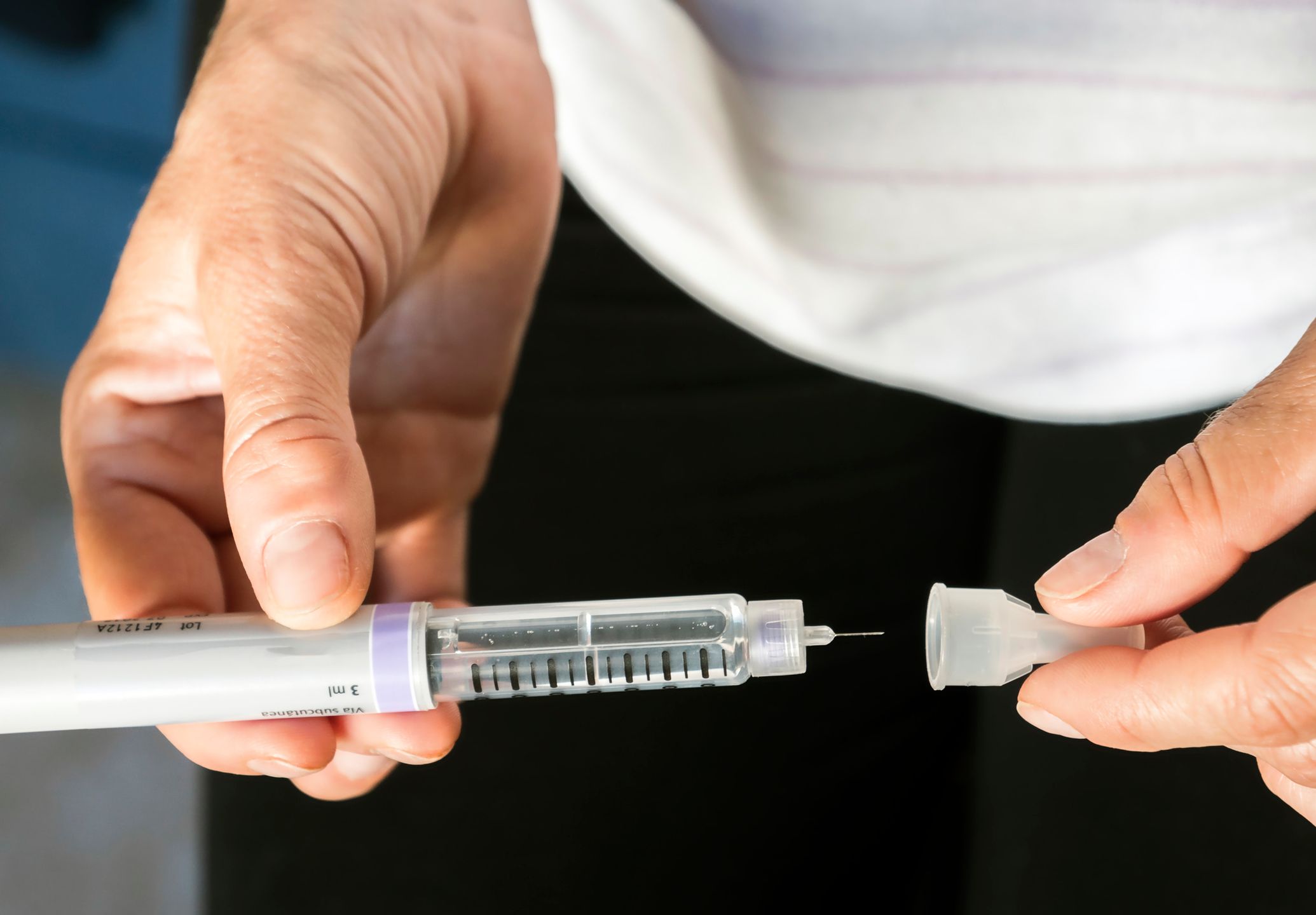 Woman examining treatment of insulin, conceptual image