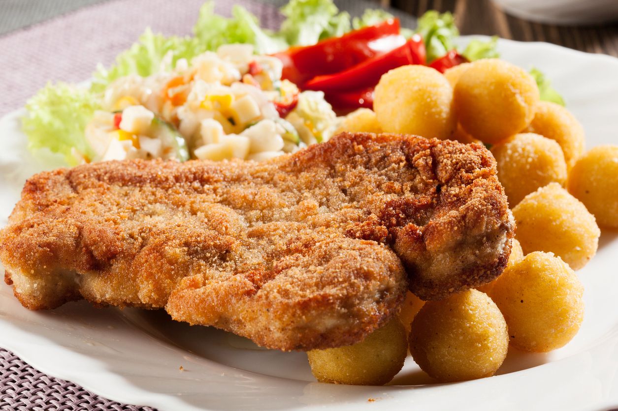 Tradycyjny zestaw obiadowy w polskim domu to kotlet schabowy, ziemniaki i surówka.