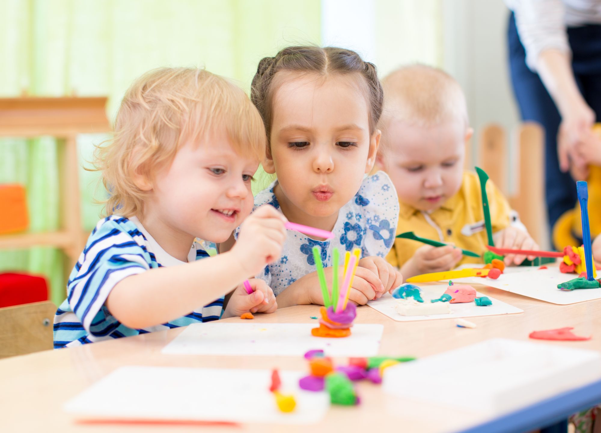 happy kids modeling or playing in kindergarten with interest 