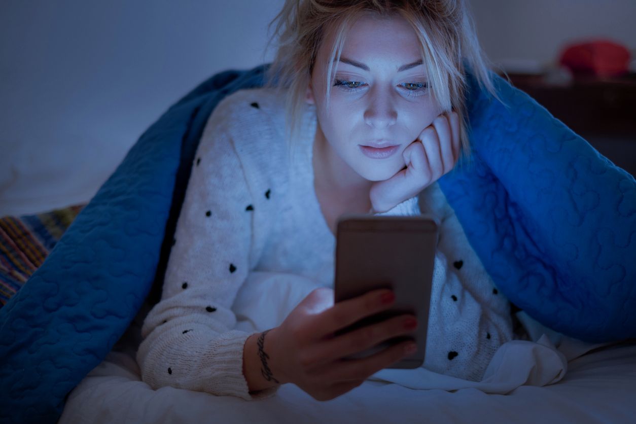 Young male freelancer searching for new concepts with blank screen smartphone 