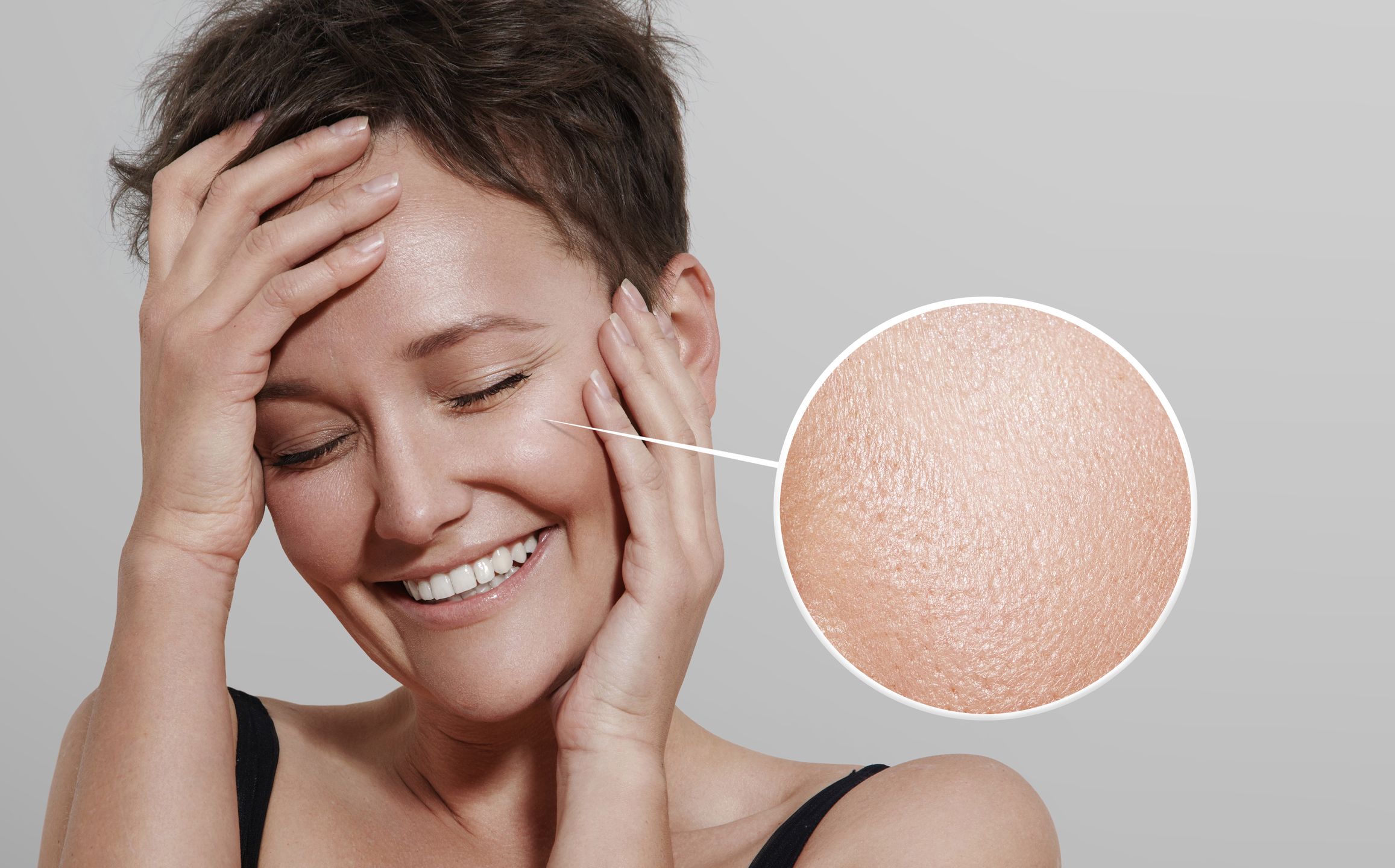 happy woman with a lens showing her ideal skin 