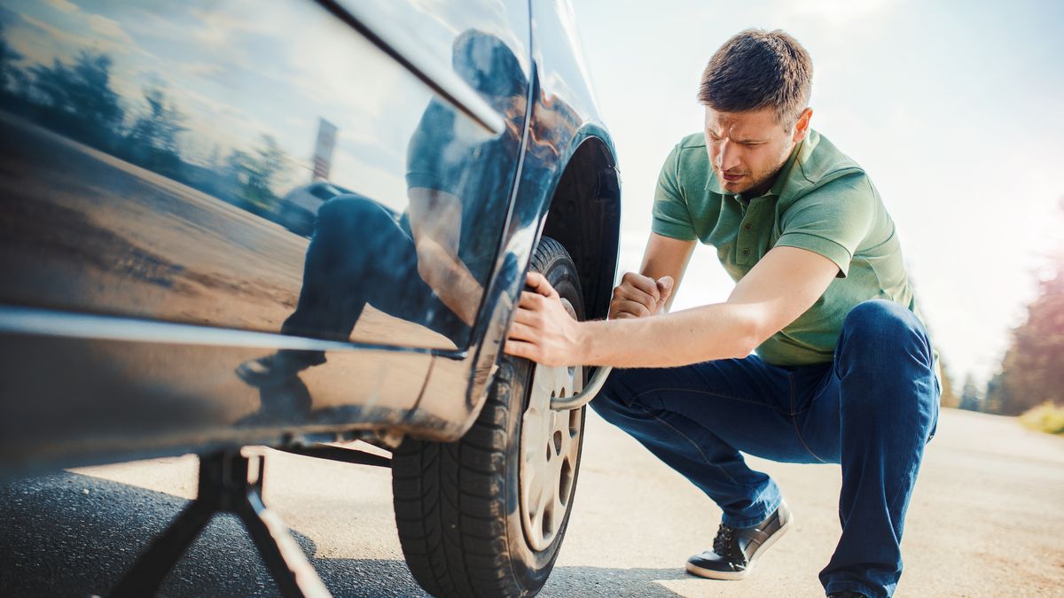 Man changing wheel after a car breakdown. Transportation, traveling concept