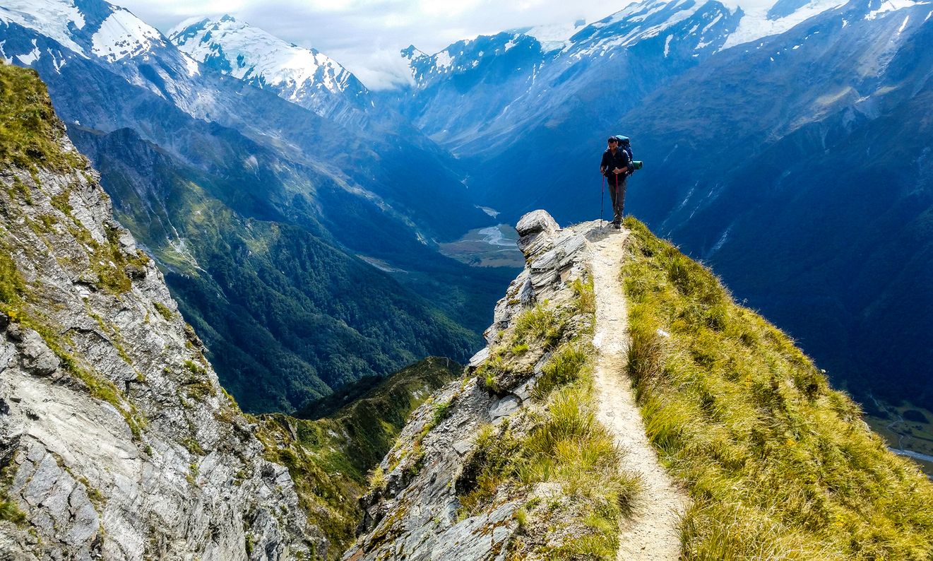 traveler at the edge of a cliff with amazing view behind him.Cascade Saddle, Mount Aspiring National Park, New Zealand (traveler at the edge of a cliff with amazing view behind him.Cascade Saddle, Mount Aspiring National Park, New Zealand, ASCII, 119  