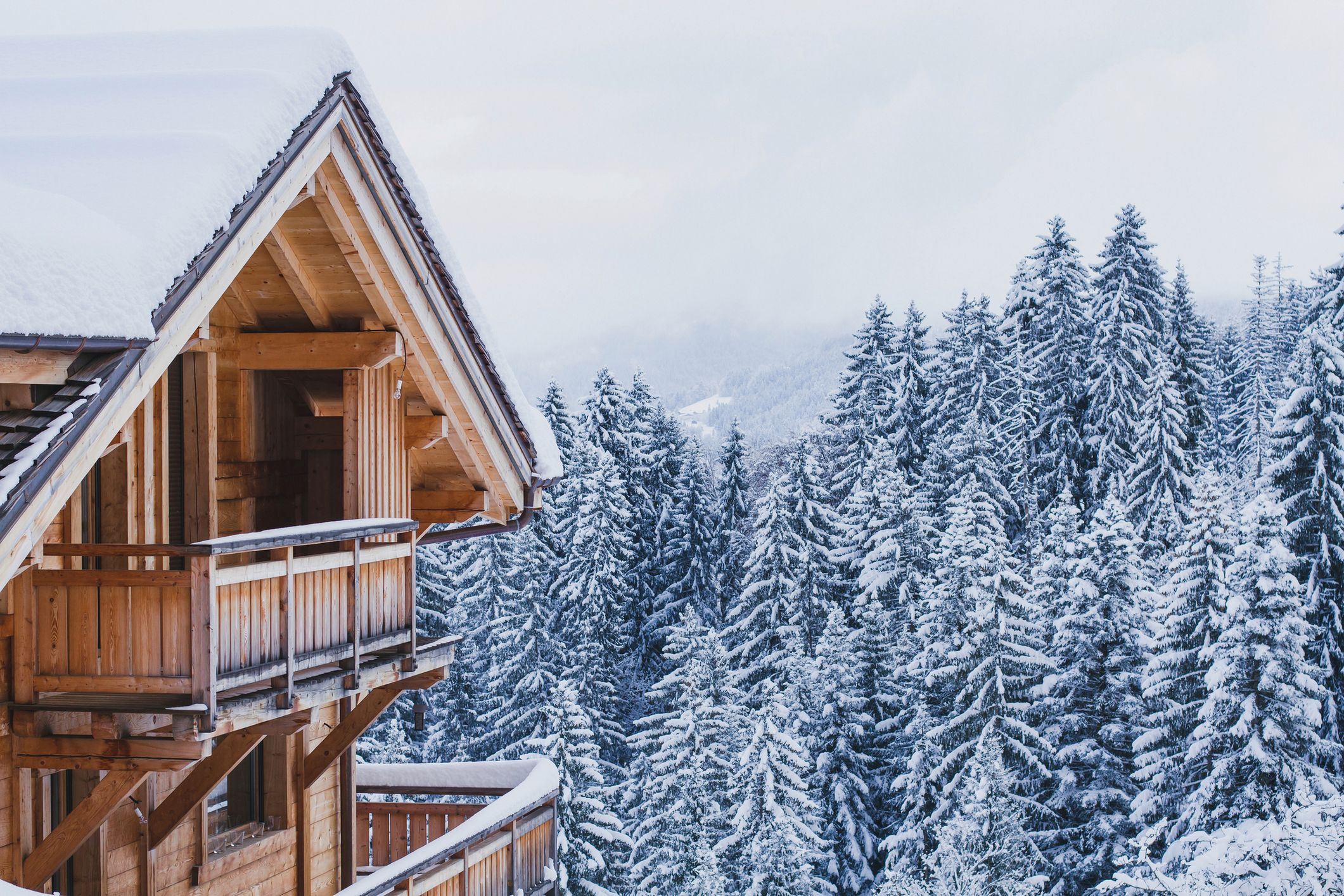 winter holidays, ski vacations background, wooden house under snow in the Alps 