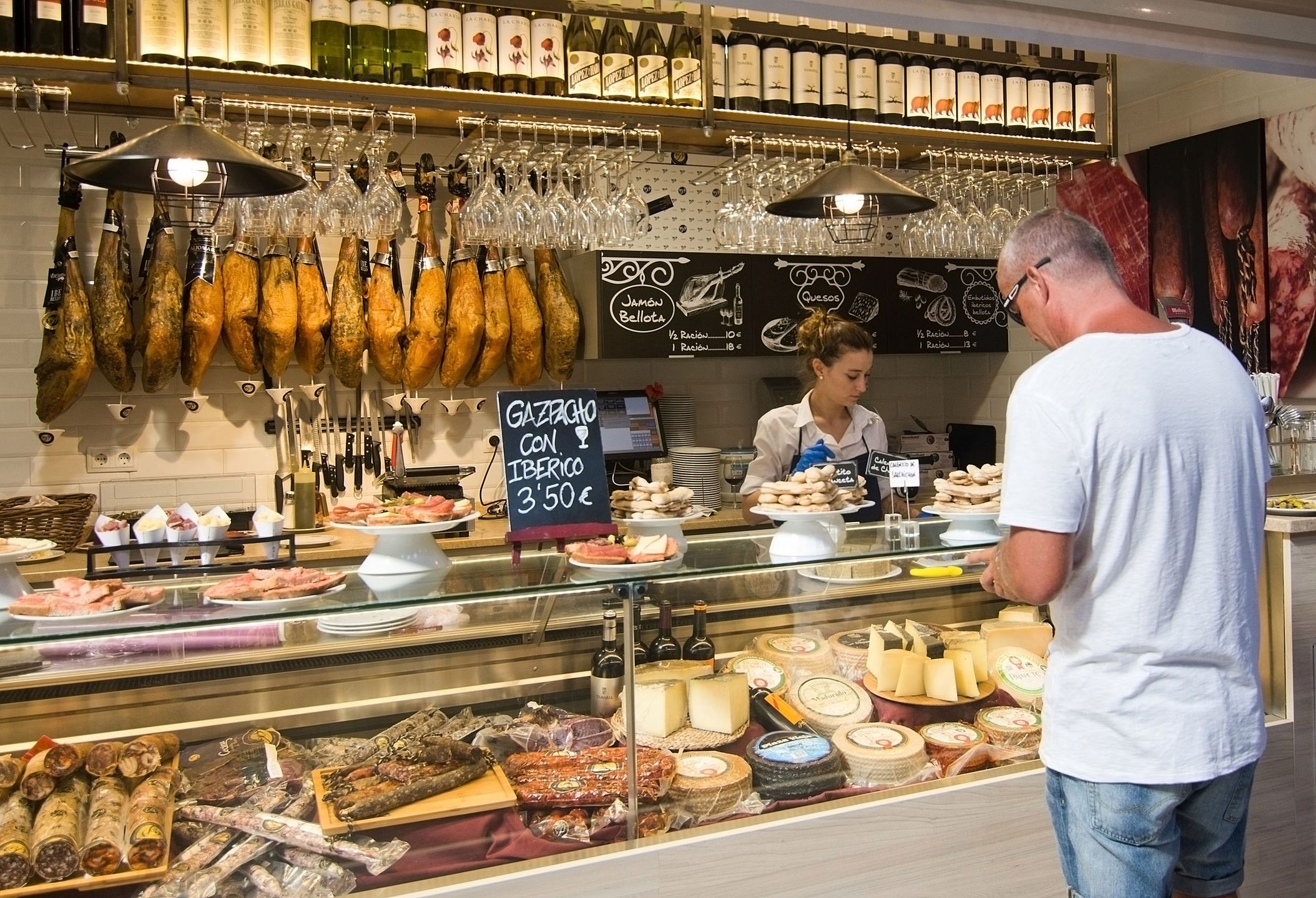 PALMA DE MALLORCA, BALEARIC ISLANDS, SPAIN - SEPTEMBER 22, 2016: Interior food court ham and cheese in Escorxador and Sant Juan Market on September 22, 2016 in Palma de Mallorca, Balearic islands, Spain. 