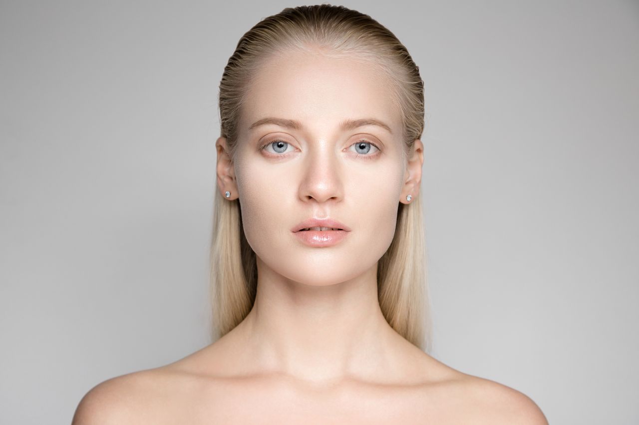Portrait Of A Beautiful Young Blond Woman With Long Slicked Hair