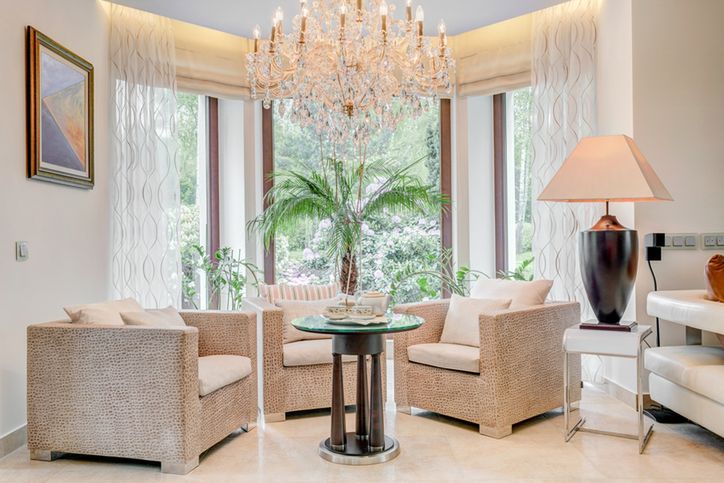 Fancy armchairs in the living room with bay window 