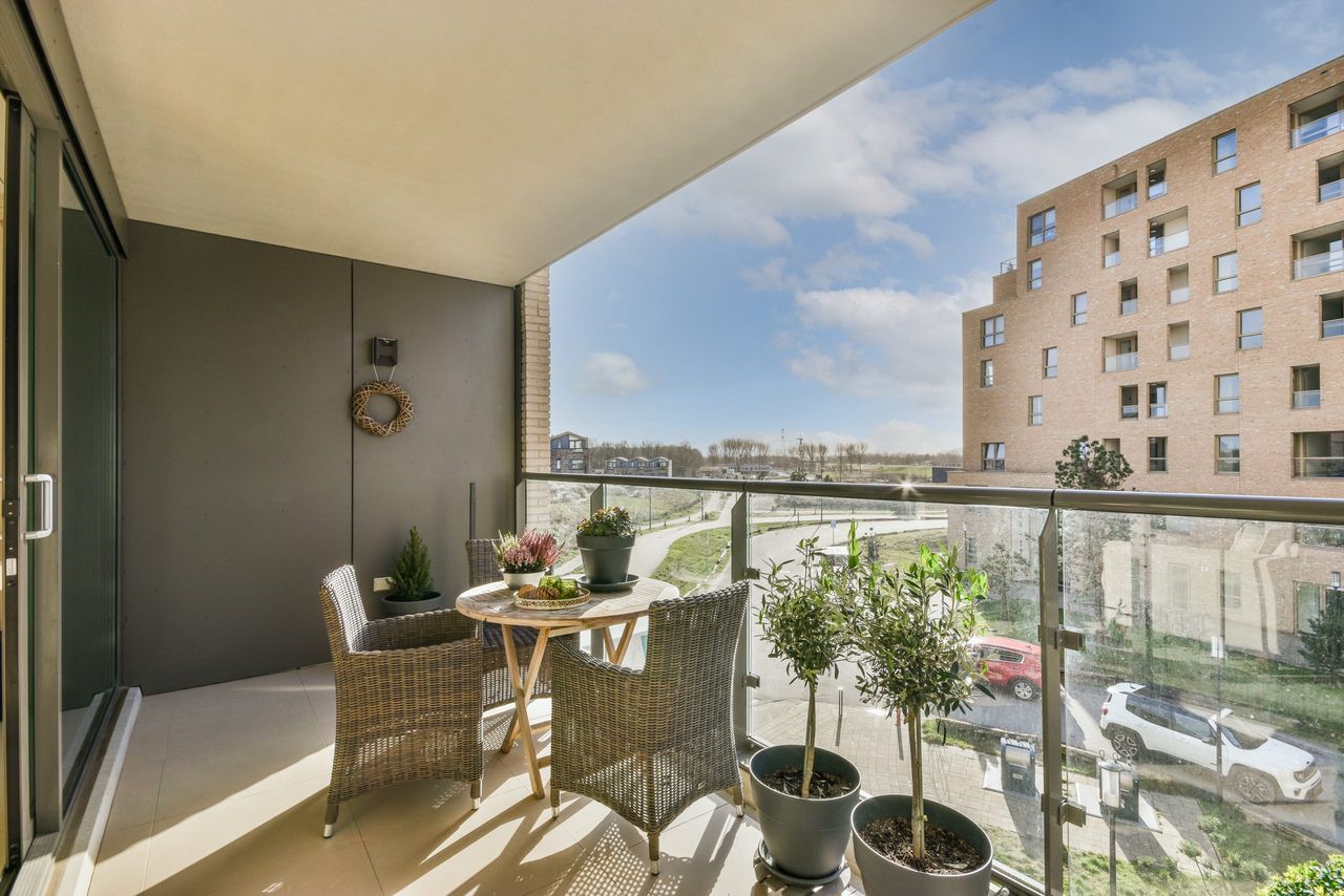 Sitting area in balcony with comfortable furniture around beautiful view