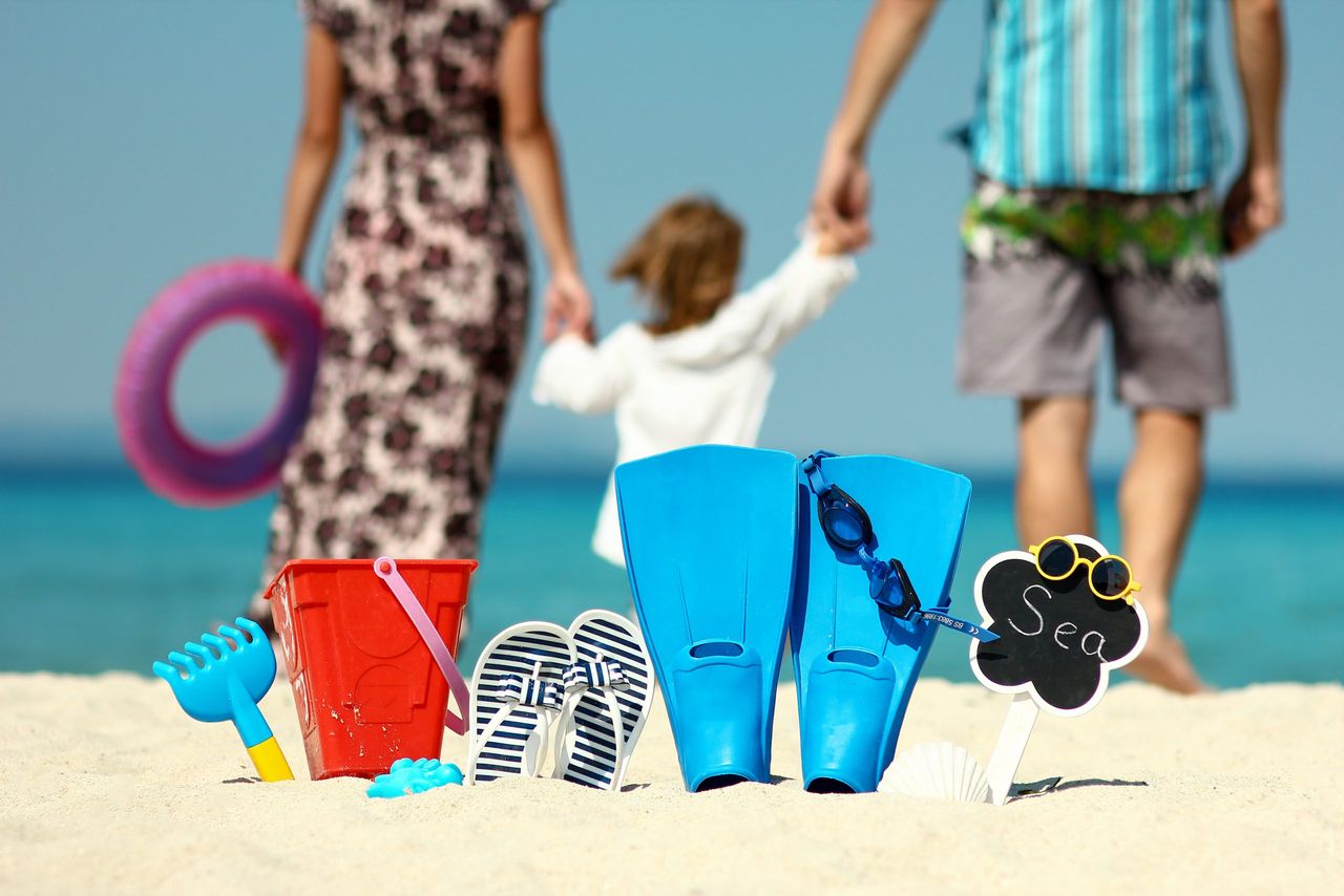 Happy family on the beach
with flippers and toys