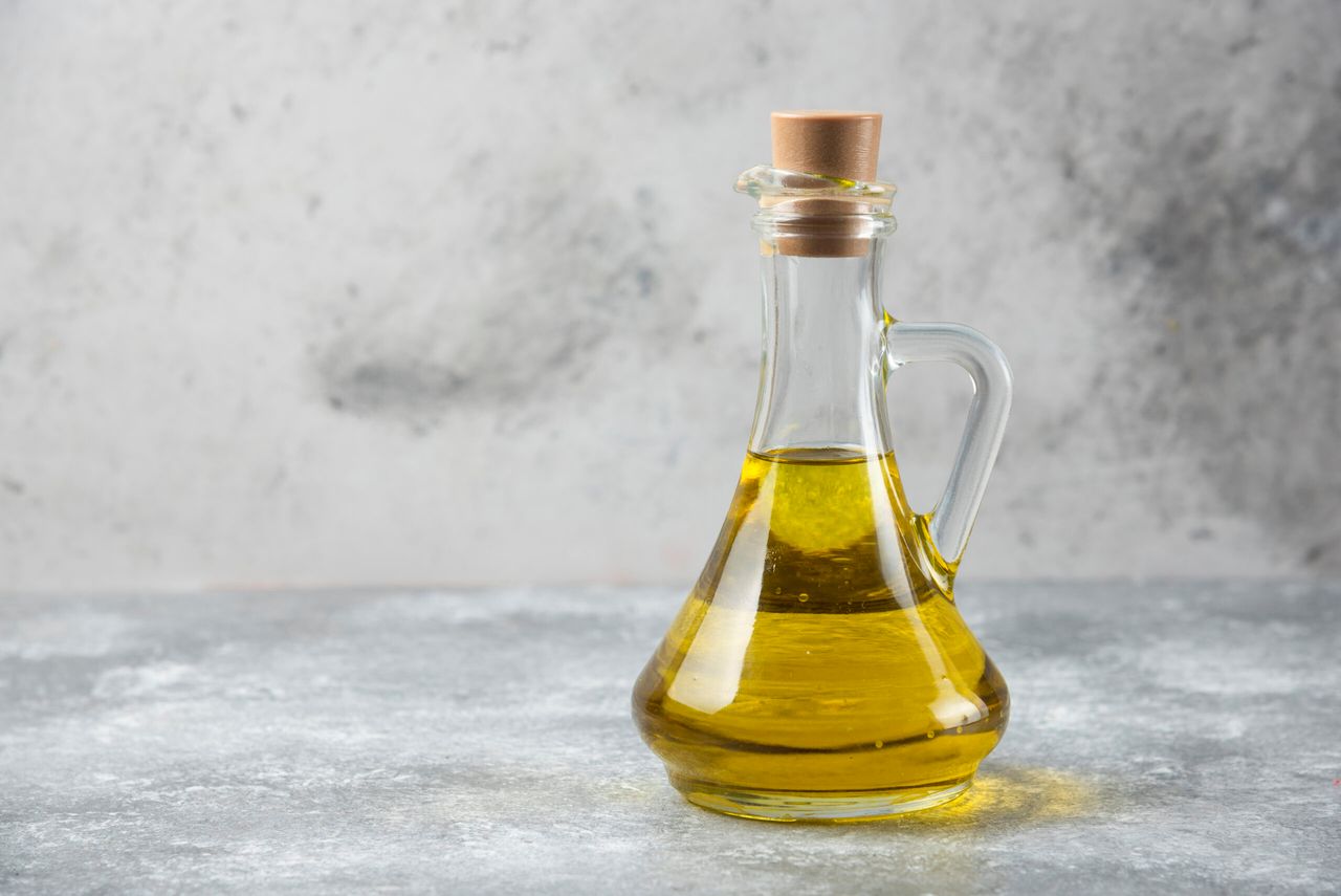 Olive oil bottle on marble table. High quality photo