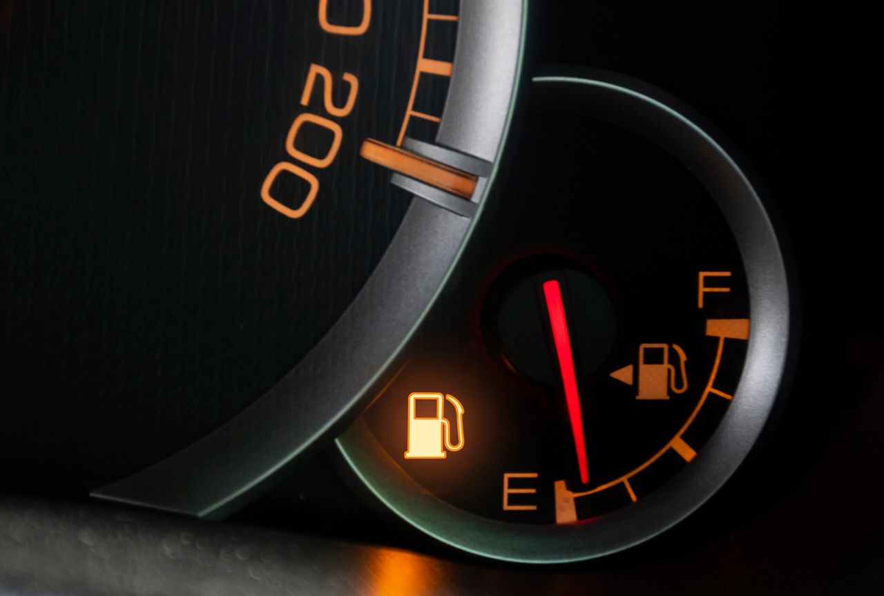 Oil level gauge show icon low fuel warning on car dashboard