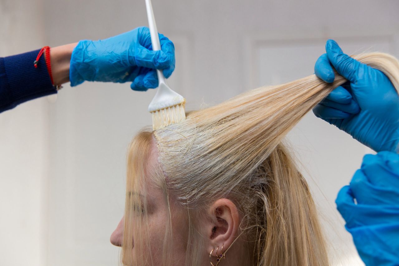 Grodno, Belarus - October 20, 2016: Participants of the seminar dye the hair of a model on advertising workshop of Keune brand in the beauty salon Kolibri.