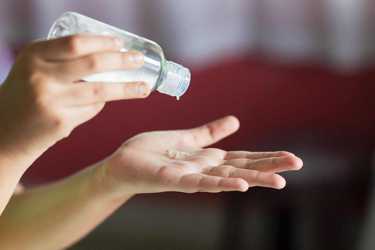 A closeup shot of hands using hand sanitizer