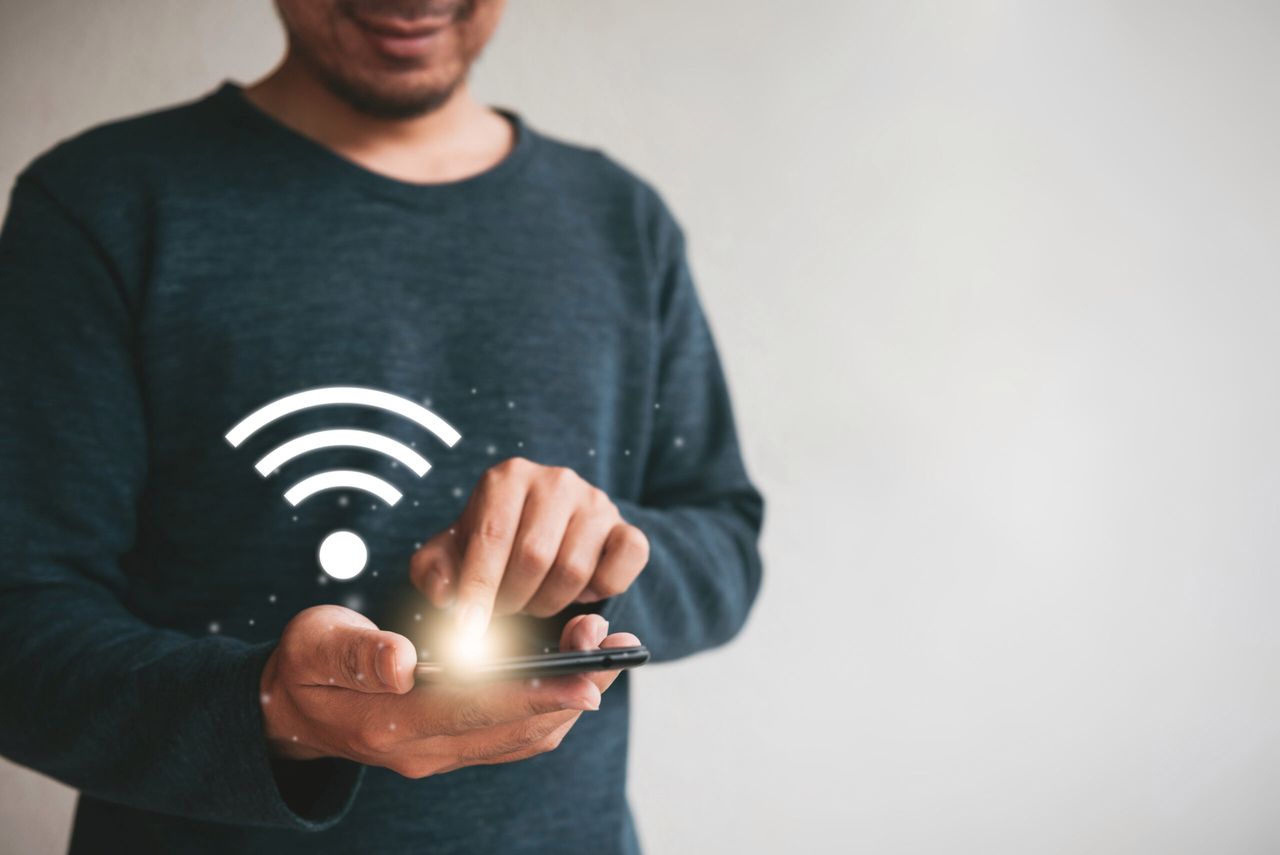 Close up hands holding smartphone. man using cellphone connecting wifi for marketing and searching data and social media on internet.technology business investment concept