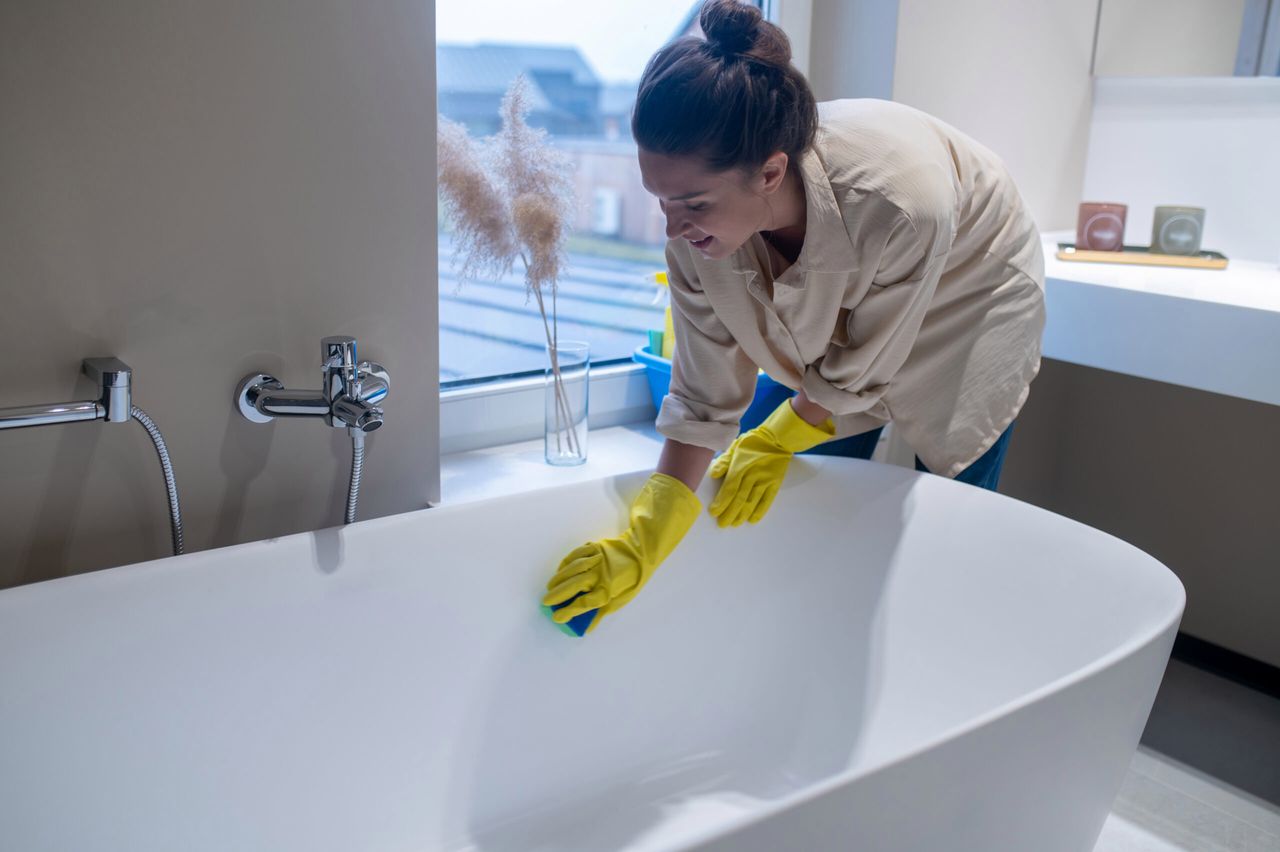 Cleaning. A woman doing cleaning at home and disinfecting the bathroom