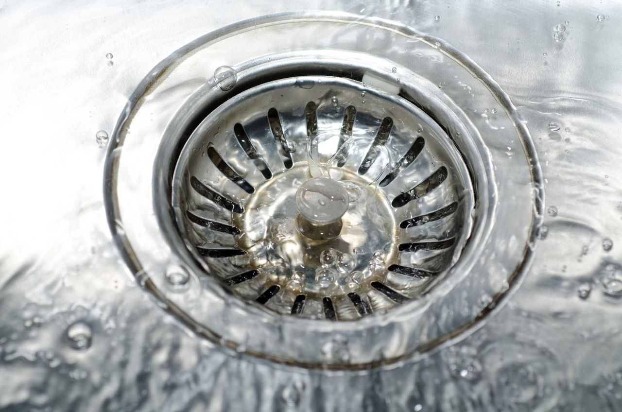 A high angle closeup shot of water pouring on the water drain