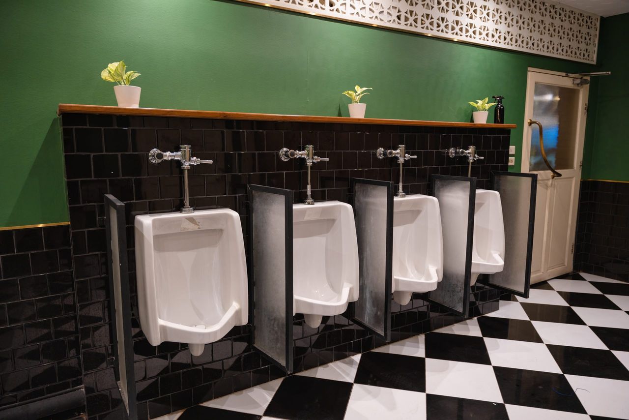 Row of urinal toilet ceramic white blocks in vintage restroom for man