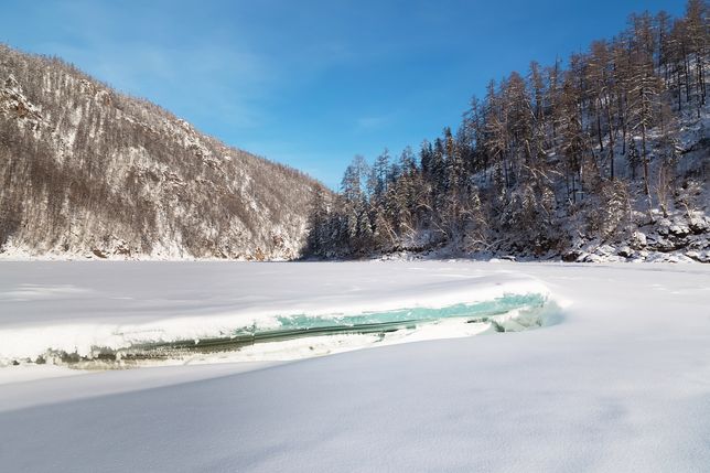 Winter landscape with frozen river and ice floe in the foreground, South Yakutia, Russia 