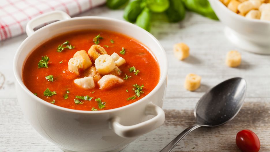 Traditional tomato soup, served with croutons. Front view.