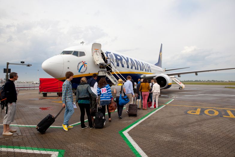A queue of travelers on the tarmac preparing to board a Ryanair airplane at Stansted Airport in London.