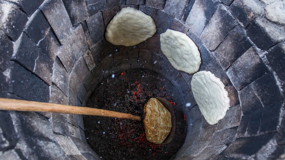 Traditional way of baking bread in the tandoor in Armeina
