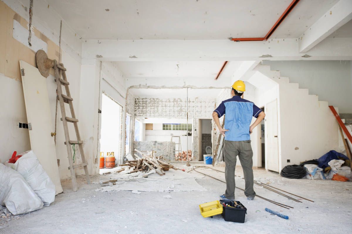 House improvement concept. Rear view of Asian construction worker looking away.