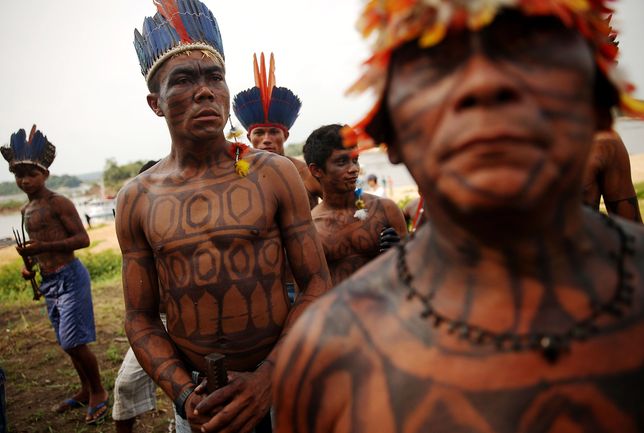 SAO LUIZ DO TAPAJOS, BRAZIL - NOVEMBER 27:  Members of the Munduruku indigenous tribe gather along the Tapajos River during a "Caravan of Resistance'" protest by indigenous groups and supporters who oppose plans to construct a hydroelectric dam on the Tapajos River in the Amazon rainforest on November 27, 2014 in Sao Luiz do Tapajos, Para State, Brazil. Indigenous groups and activists travelled by boat from communities along the river to express resistance to the proposed 8.040- MW Sao Luiz do Tapajos mega-dam, which is one of a series of five dams planned in the region that will flood indigenous lands and national parks. The United Nations climate conference is scheduled to begin December 1 in neighboring Peru. (Photo by Mario Tama/Getty Images) 