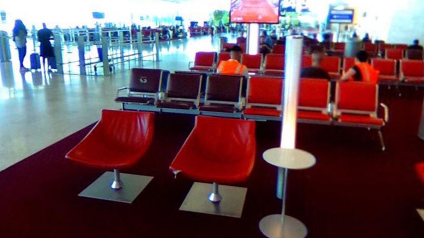 Czerwone wykładziny na paryskim lotnisku Charles de Gaulle. Zaraz obok znajduje się ściana z bujną roślinnoscią.