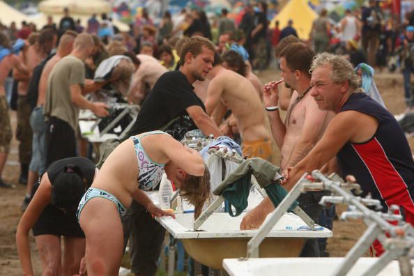 KOSTRZYN, POLAND - AUGUST 02:  Visitors wash at the three-day International Woodstock Festival on August 2, 2008 in Kostrzyn, Poland. Hundreds of thousand of fans attend the annual festival to hear bands play a wide variety of music on an open field near Kostrzyn, close to the German and Polish border.  (Photo by Sean Gallup/Getty Images) 