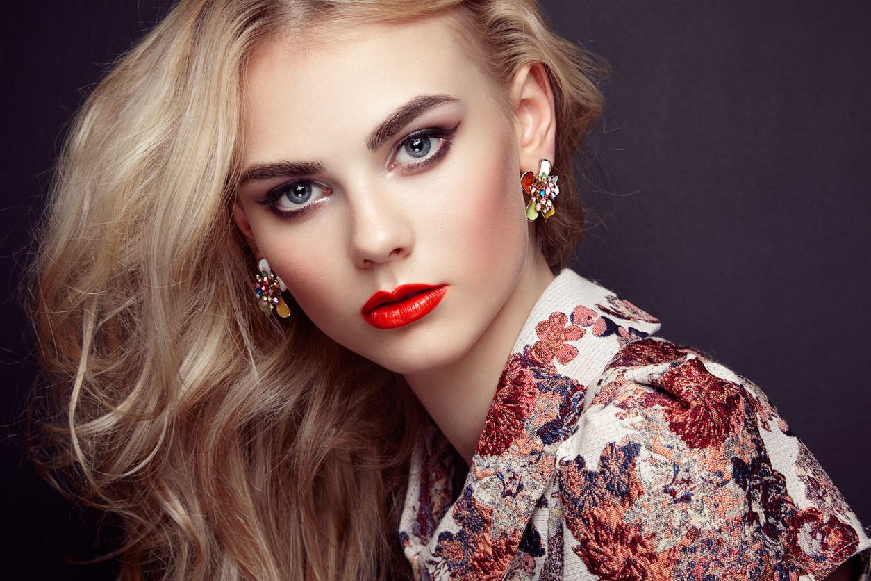 Portrait of beautiful sensual woman with elegant hairstyle.  Perfect makeup. Blonde girl. Fashion photo. Jewelry and dress 