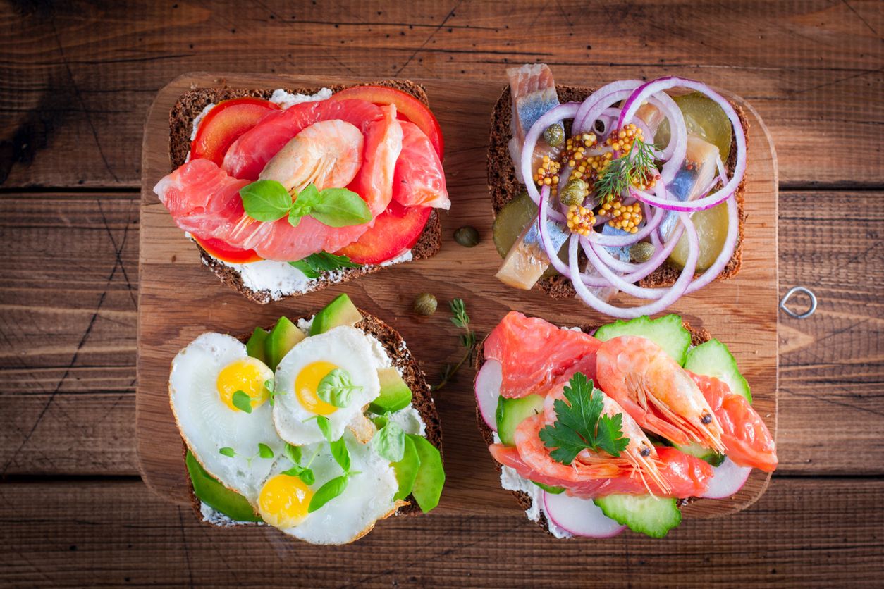 Smorrebrod, traditional Danish open sanwiches, dark rye bread with different topping, 